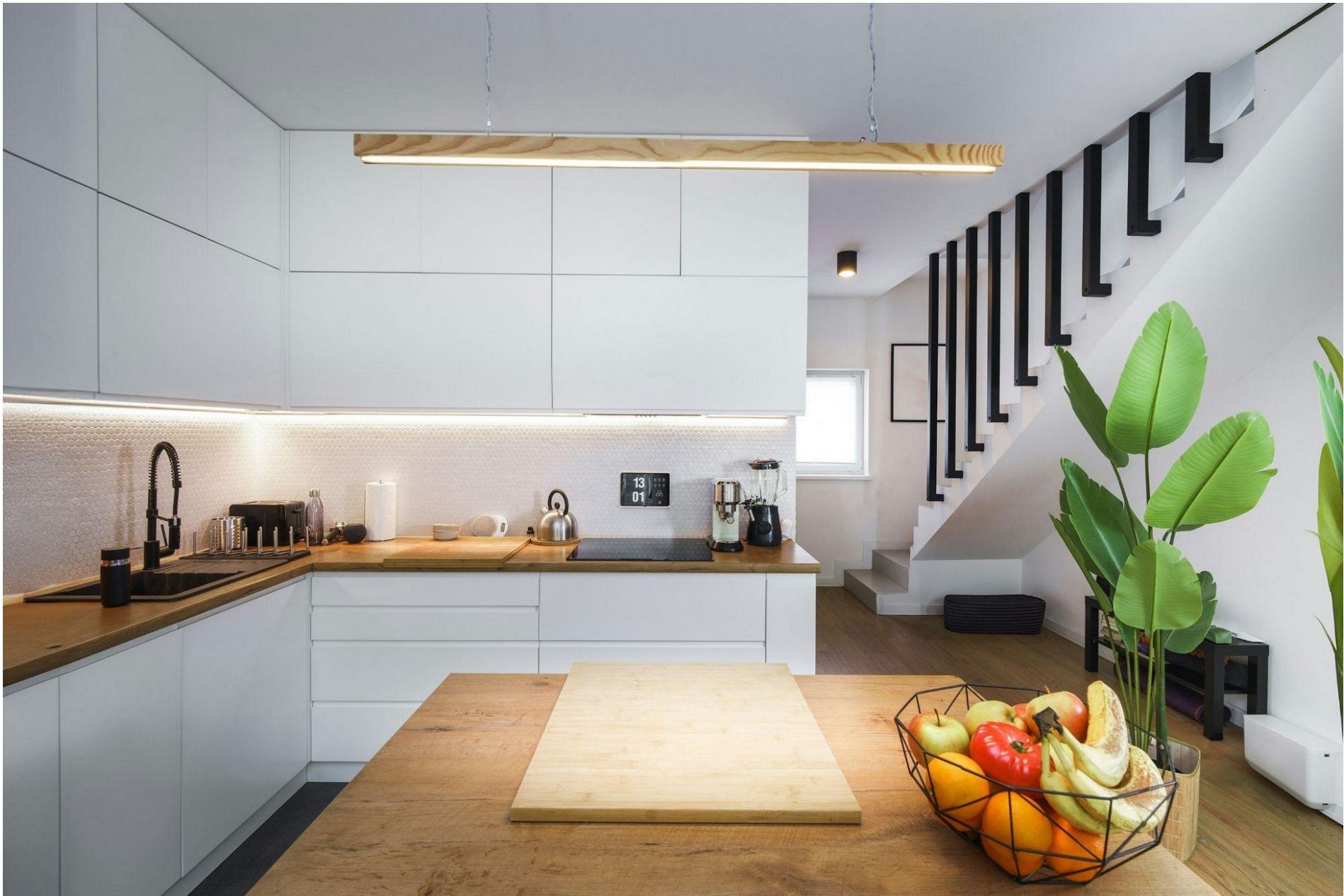 A modern kitchen with a smart thermostat mounted on the wall